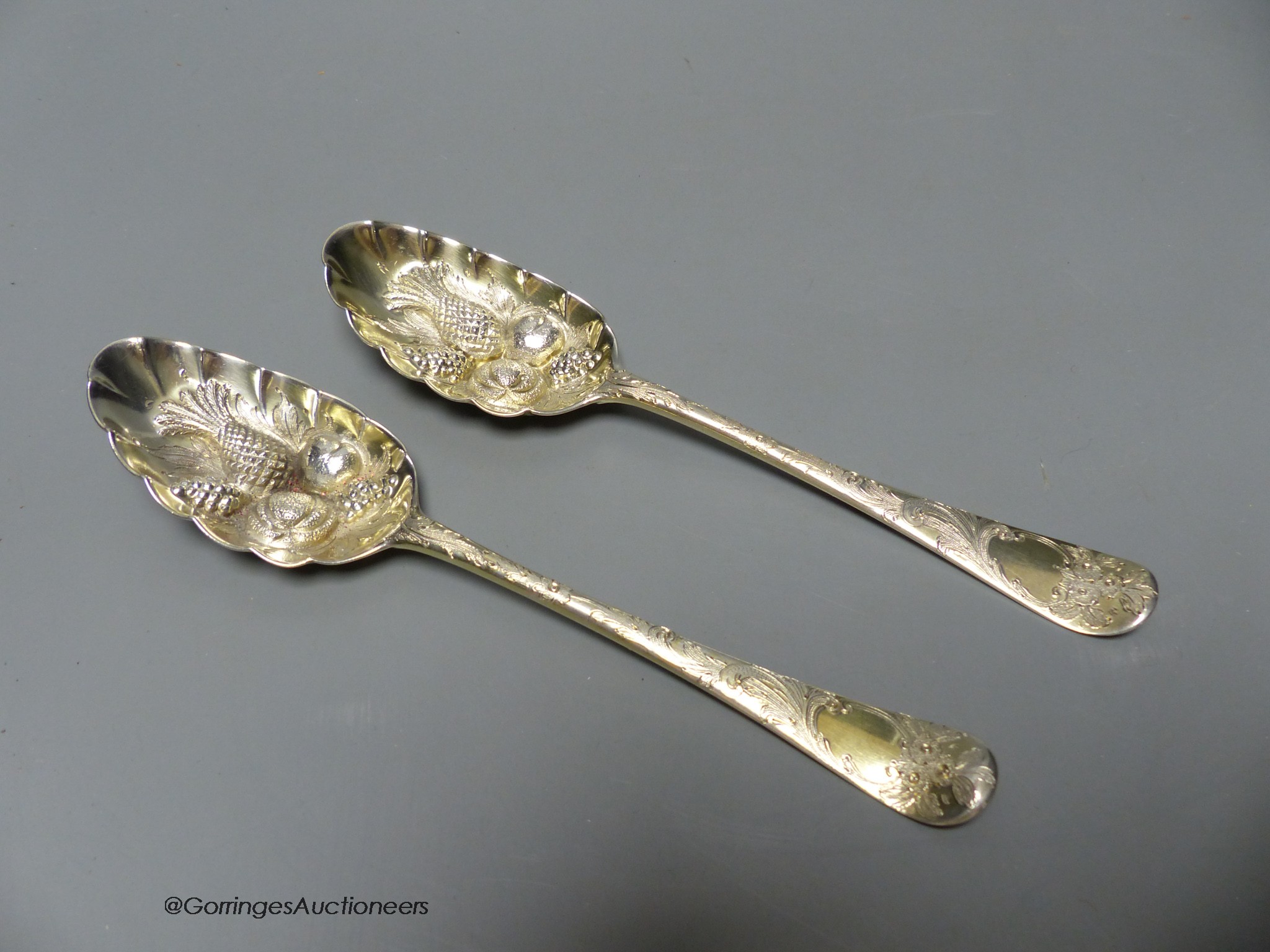 A pair of 18th century silver 'berry' spoons by Ebenezer Coker (marks rubbed and pinched), 19.8cm, 126 grams.